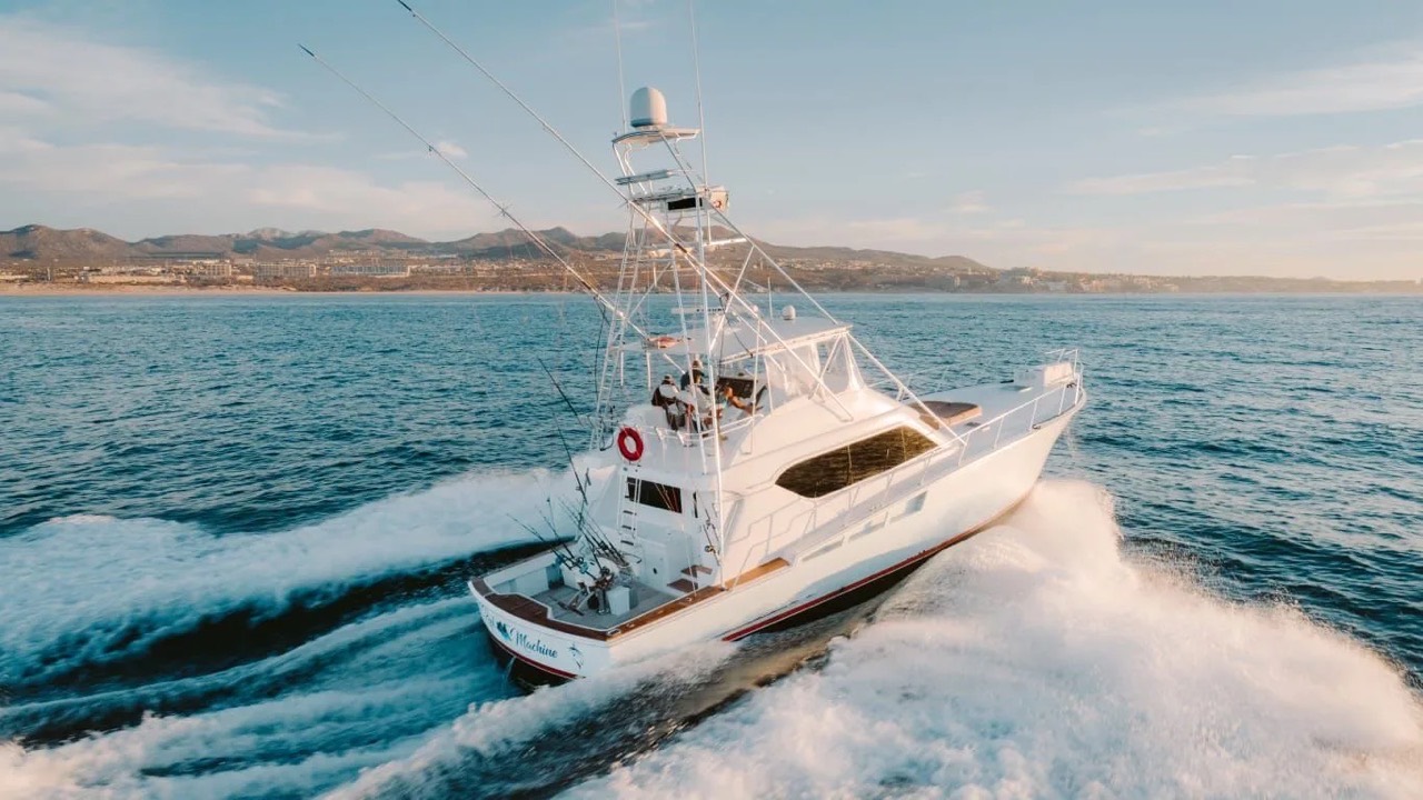 Sportfishing boat throwing up a wake at sunset